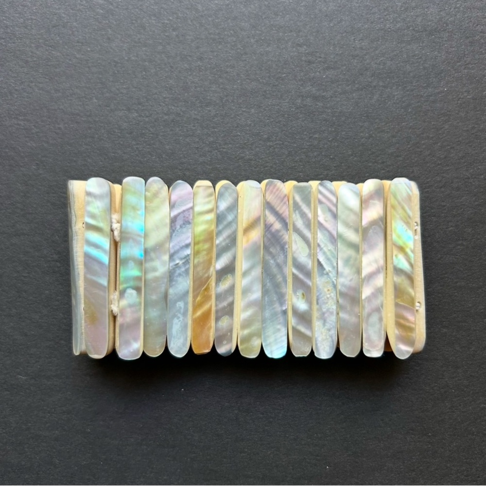 Colorful expandable bracelet. Looks & feels like seashell material.
